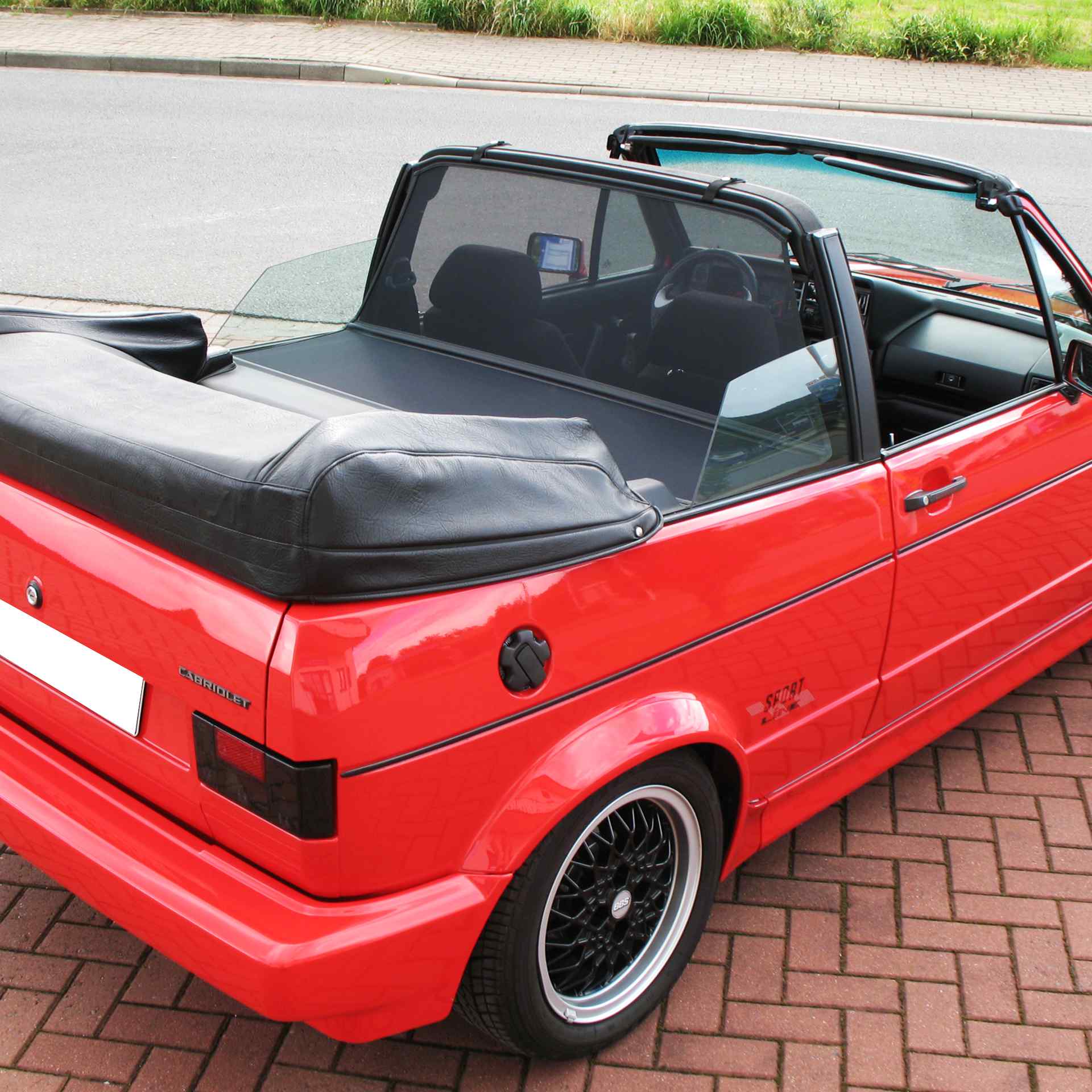 a red vw golf 1 convertible with a bodi xl wind deflector
